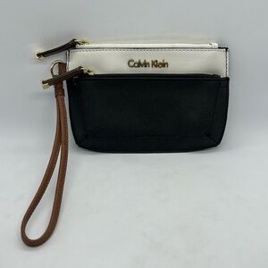 Calvin Klein Faux Leather Wristlet, 6-3/4” x 4-3/4”. Ivory, Black, Brown.